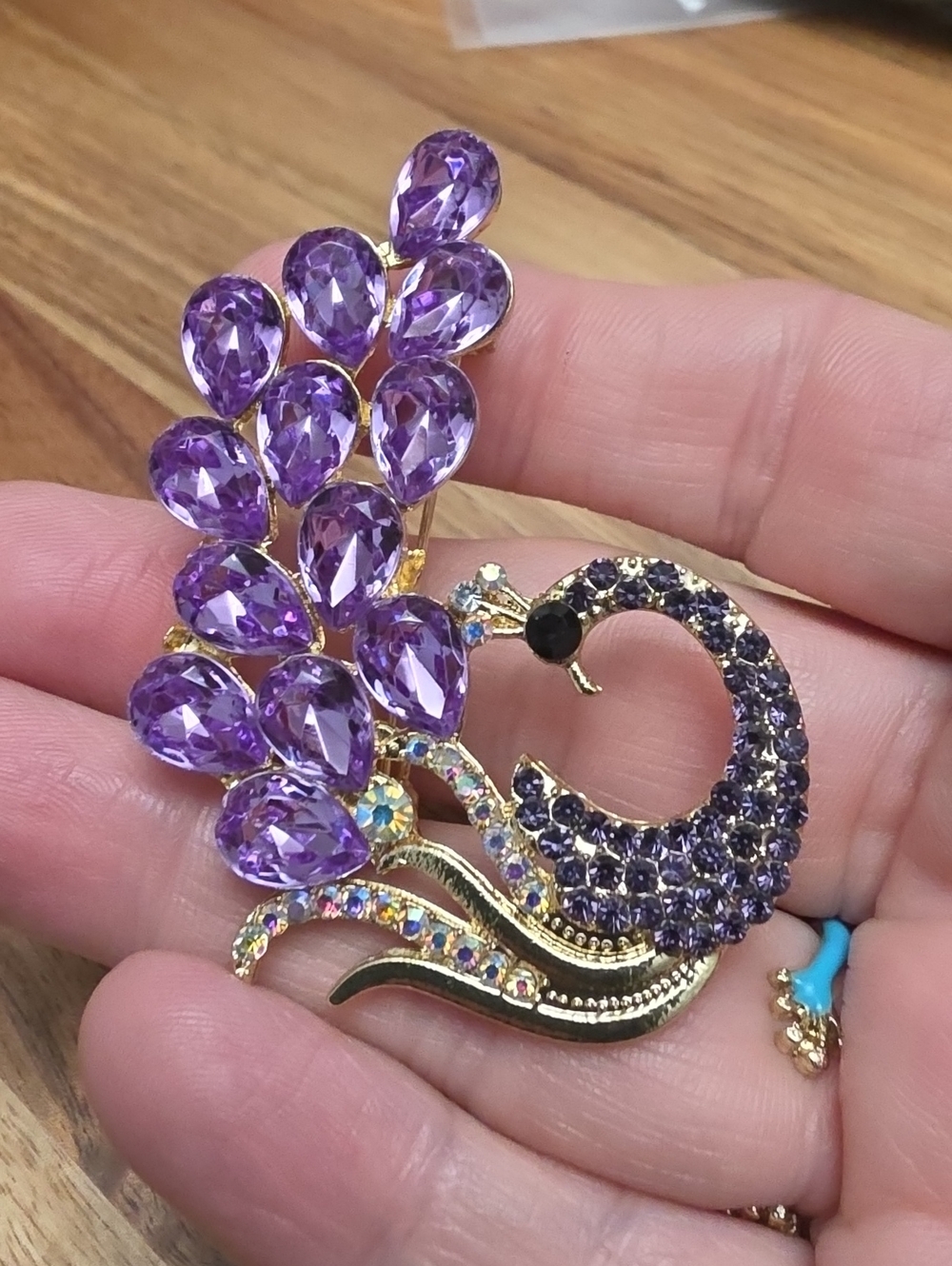 A106- Gold Peacock Brooch with Purple Crystal Plumage